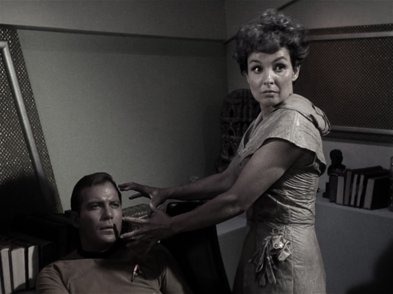 "In Kirk's cabin aboard the Enterprise, McCoy raised the phaser, his heart torn between duty and the haunting visage of Nancy Crater. The Salt Vampire, poised to strike at the stunned Captain Kirk, bore the guise of lost love—a cruel mockery of memory and desire. McCoy's resolve hardened, a testament to the sacrifices demanded by survival."